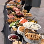 A buffet table with a lot of food on it.