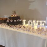 A table with cupcakes and a sign that says love.