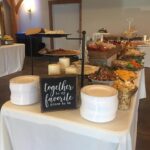 A buffet table with a sign that says together forever.