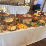 A buffet table with a variety of foods on it.