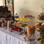 A buffet table with a variety of snacks and desserts.