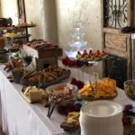 A buffet table with a lot of food on it.