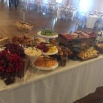 A buffet table with a lot of food on it.