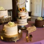 Four cakes on a table with a purple tablecloth.