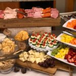 A buffet table with a variety of food on it.