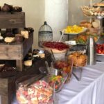 A buffet table with a variety of snacks and desserts.