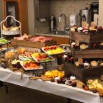 A buffet table with a variety of food on it.