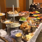 A buffet table with a variety of food on it.