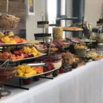 A buffet table with a variety of food on it.