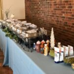 A buffet table with a variety of food on it.