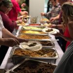 A group of people at a buffet.