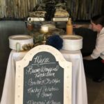 A woman is preparing a buffet at a wedding.