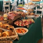 A buffet table with a variety of food on it.