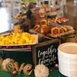 A buffet table with a variety of food on it.