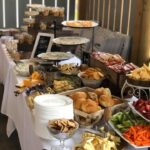 A buffet table with a variety of food on it.