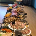 A buffet table with a variety of food on it.