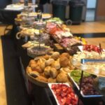 A buffet table with a variety of food on it.