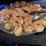 A tray of appetizers with salmon on it.