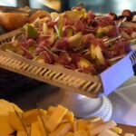 A tray of cheese and meat on a table.