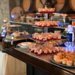 A buffet table with a variety of food on it.