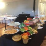 A buffet table with a variety of food on it.