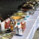 A buffet table with a variety of food on it.