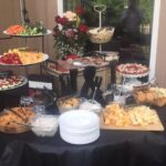 A buffet table with a variety of food on it.