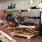 A buffet of cookies and cookies on a wooden table.