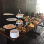 A buffet with a variety of food on a table.