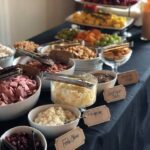 A buffet table with a variety of food on it.