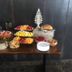 A buffet table with a variety of food on it.