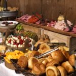 A buffet table with a variety of food on it.