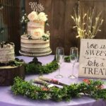 A table with a cake and a sign on it.