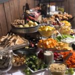 A buffet table with a variety of food on it.