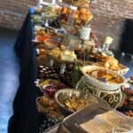 A buffet table with a lot of food on it.