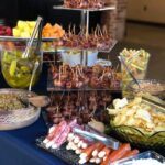 A buffet table with a variety of food on it.