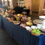 A buffet table with a lot of food on it.