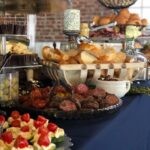 A buffet table with a variety of food on it.