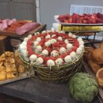 A buffet table with a variety of food on it.