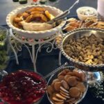 A table with a variety of snacks and desserts.