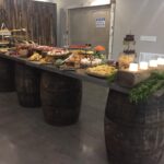 A wooden table with a lot of food on it.