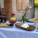 A dessert table with a chocolate fountain and cookies.