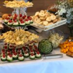 A buffet table with a variety of food on it.