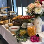 A buffet table with a variety of food and drinks.