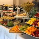 A buffet table with a variety of food on it.