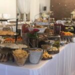 A buffet table with a lot of food on it.