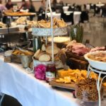 A buffet table with a variety of foods on it.