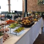 A buffet table with a lot of food on it.