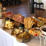 A buffet table with a variety of foods on it.