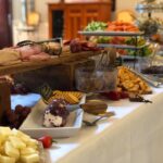 A buffet table with a variety of foods on it.